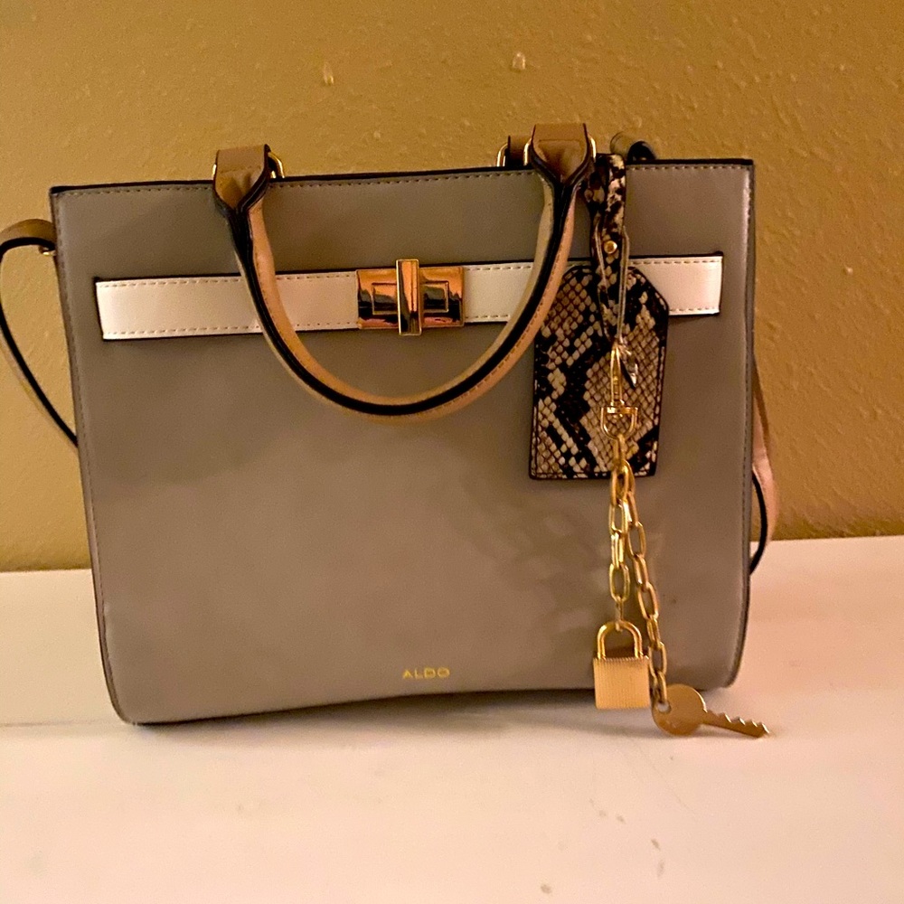 greige, beige/white details.gold chain. python tag